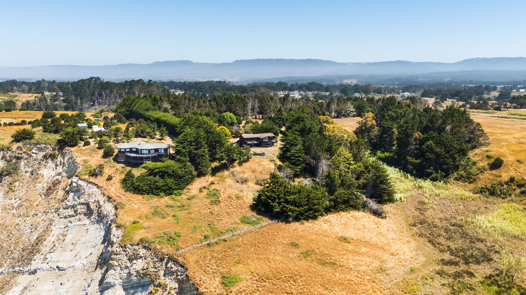 Arial view of house with blufftop and pasture