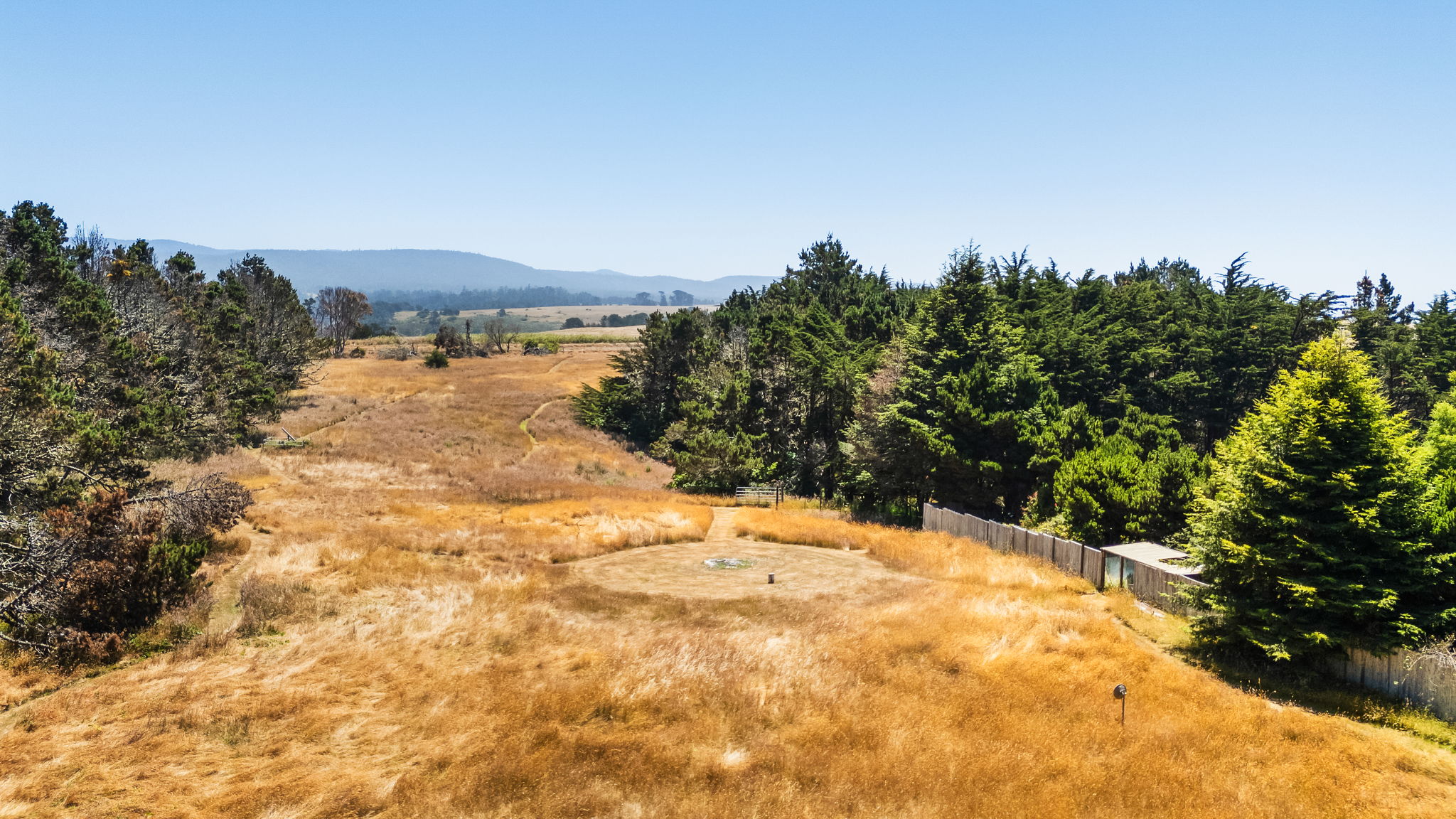 Pasture and firepit at back of property