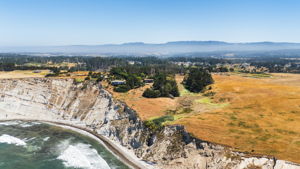 Arial view of house with blufftop and pasture