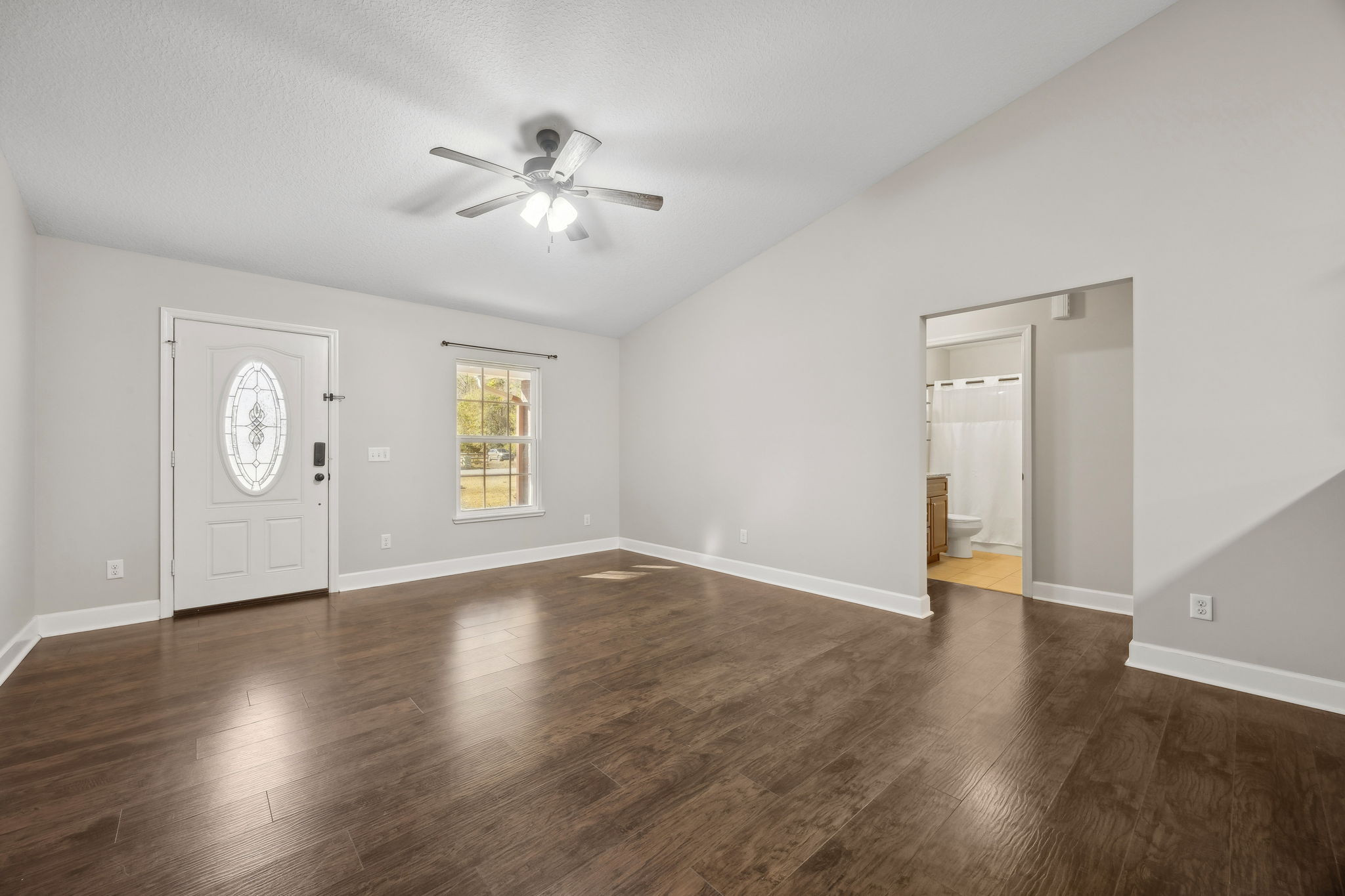 Living Room with Vaulted Ceiling and Ceiling Fan