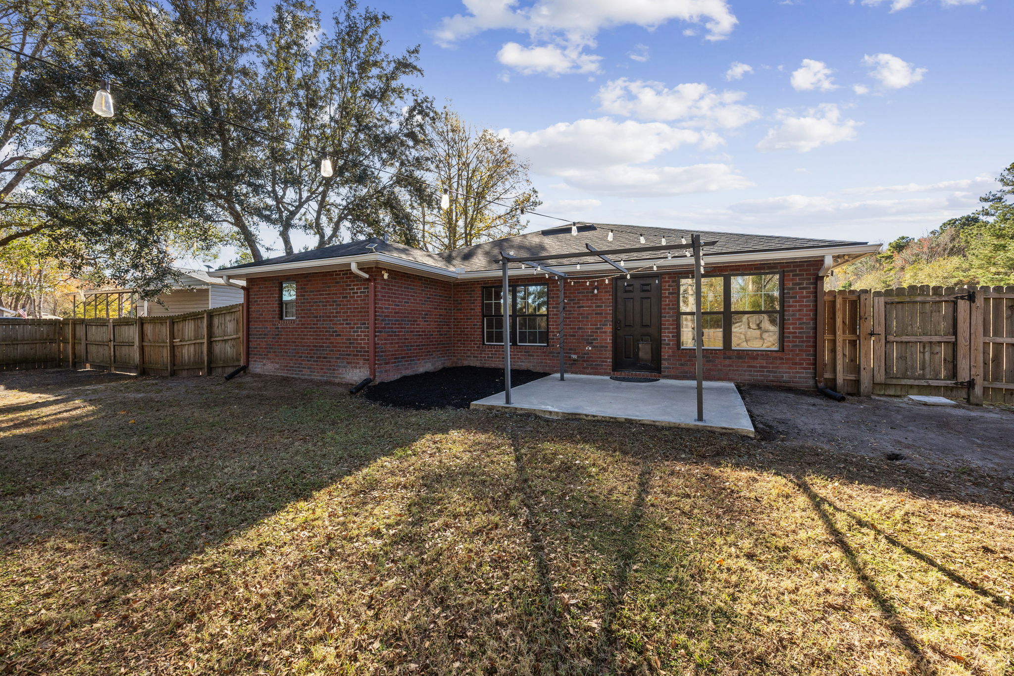 Back of Home showing Drive-Through Gate on the left and Walk-In Gate on the right