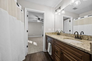 Primary Bathroom with Granite Countertops, New Fixtures, Dual Sinks and Porcelain Tile Floors