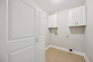 Pantry with Built-in Shelves and Laudry Room off of the Kitchen