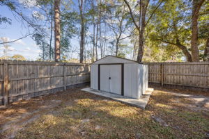 Another Storage Shed with Sliding Doors - notice solar panels on the Fence Posts