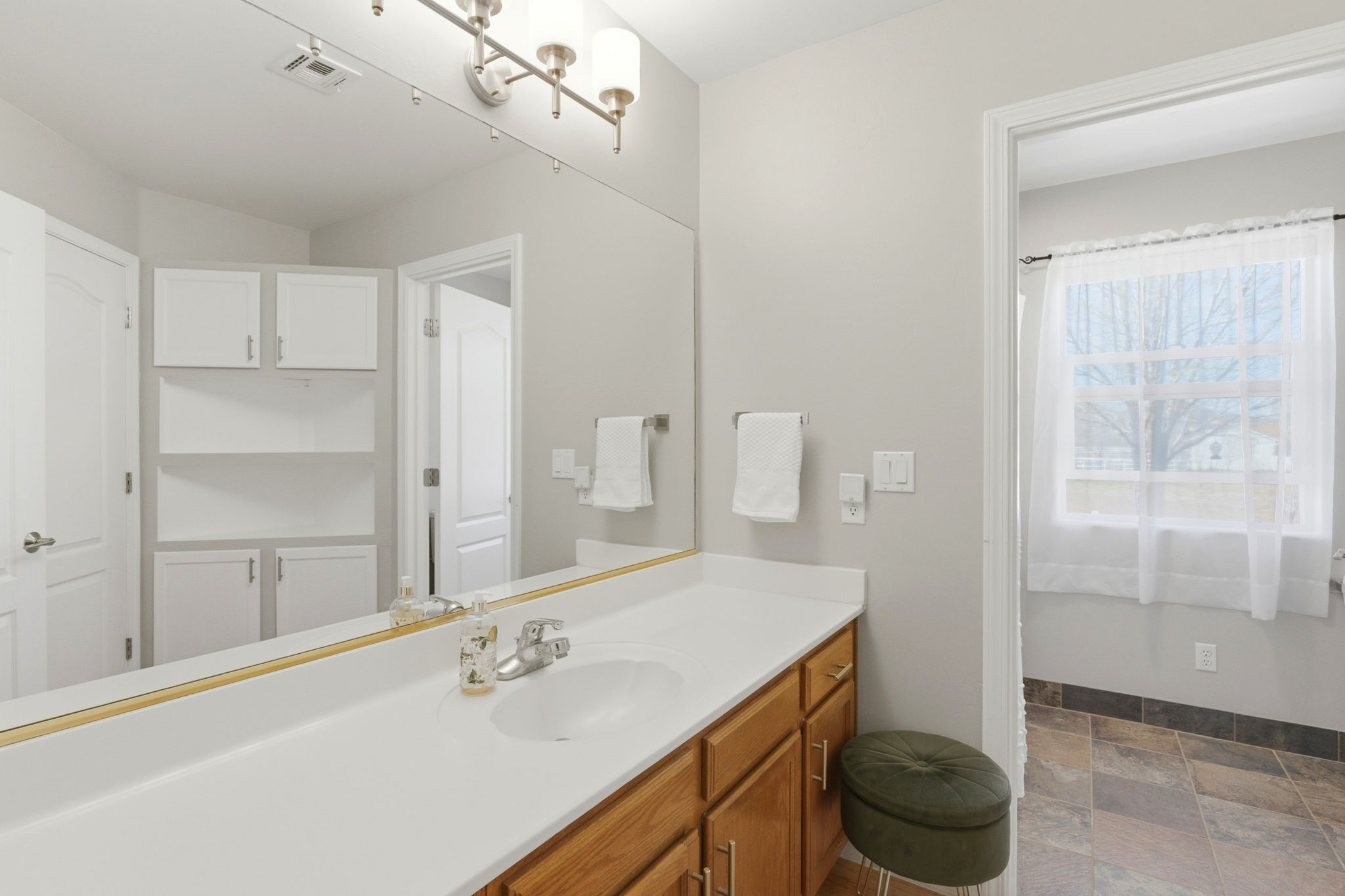 Full Guest Bathroom is Ensuite, and Accessible from the Hallway .