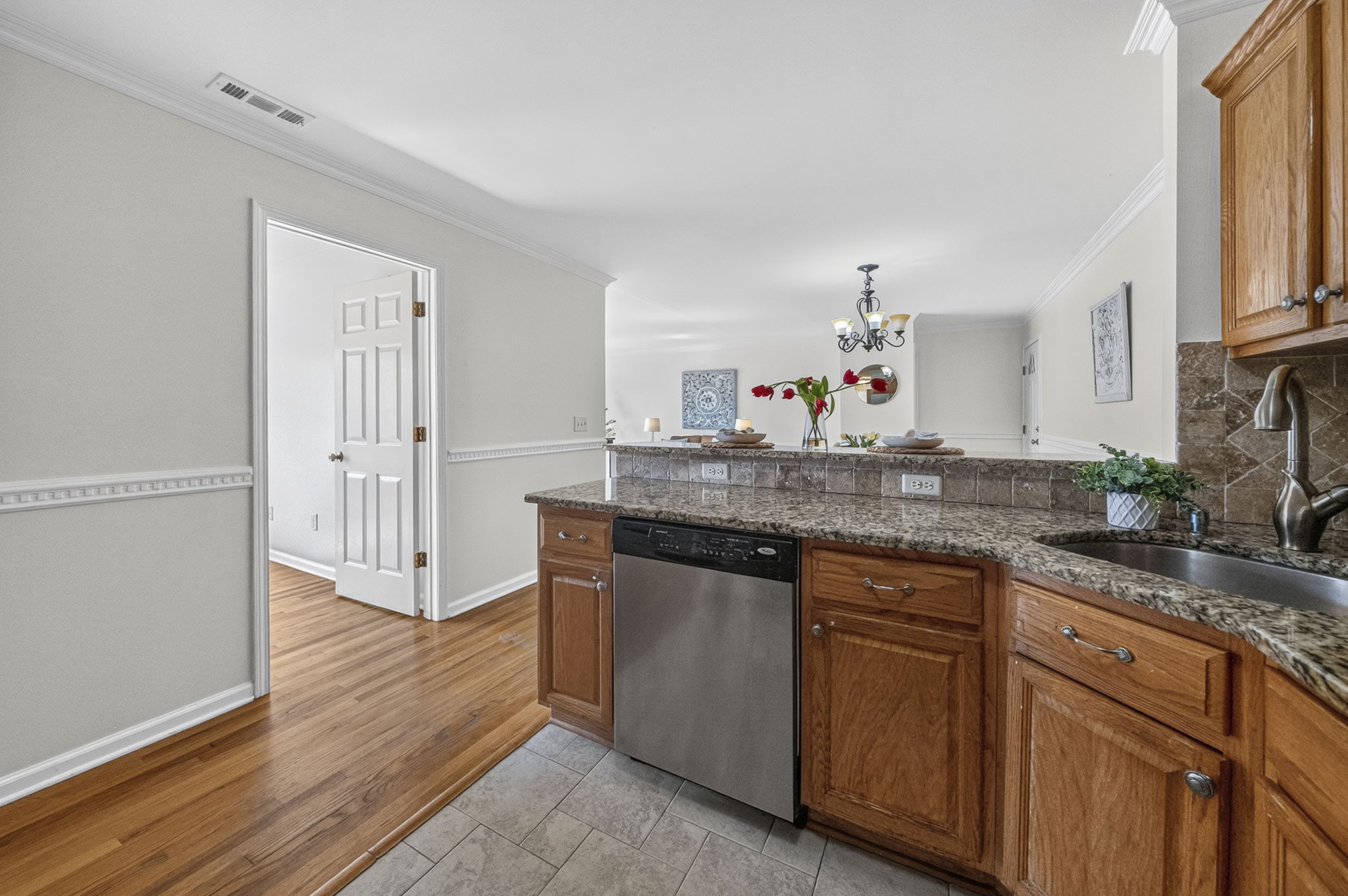 KItchen with ss appliances , including newer fridge, plenty of granite countertops, and spacious breakfast bar.