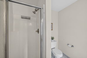 Primary Bedroom with walk in closet with built ins, valet, drawers-including a velvet two tier jewelery drawer, private bathroom with shower and attic access from WIC.