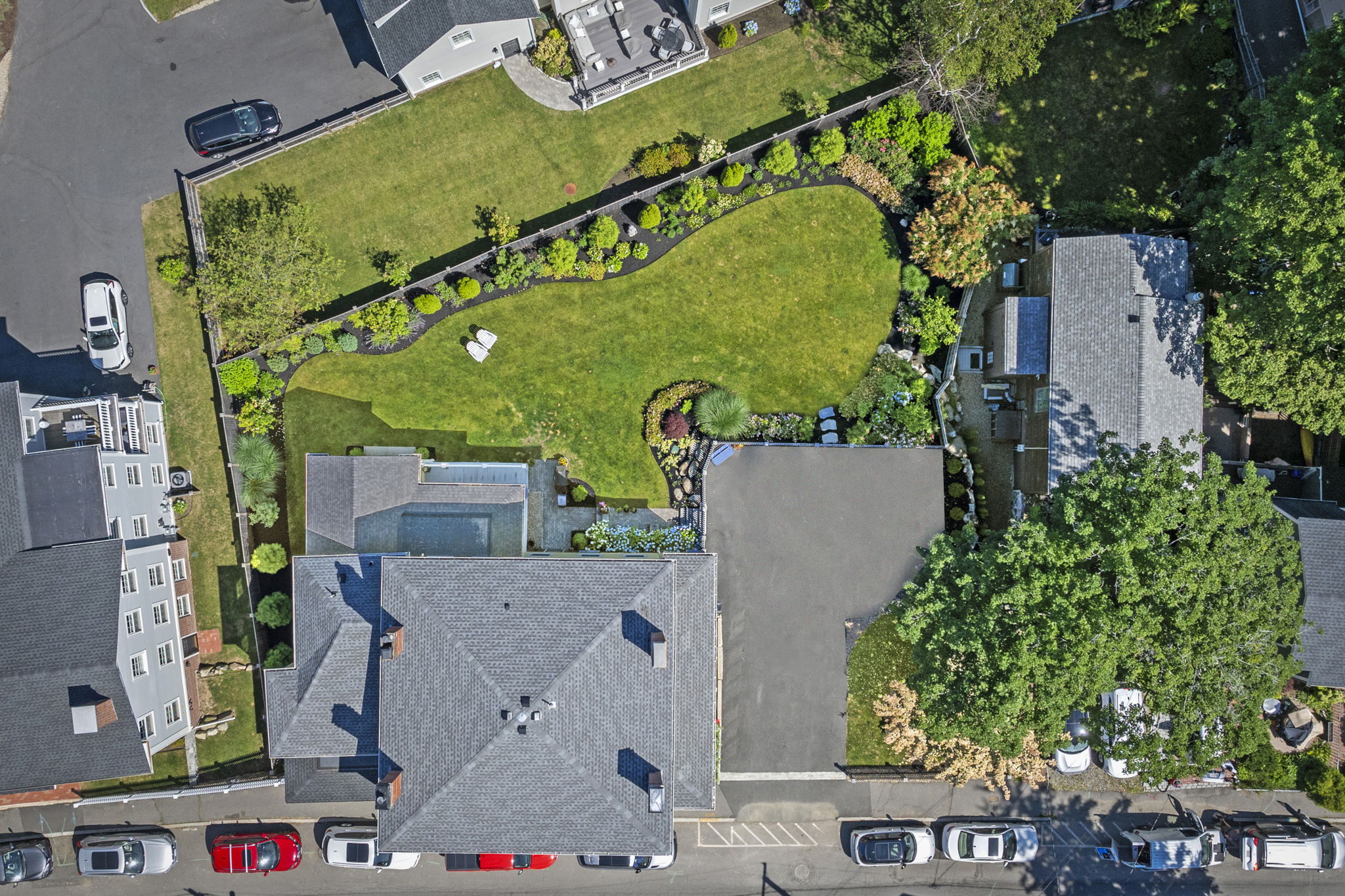 Aerial view of the home, driveway, and yard