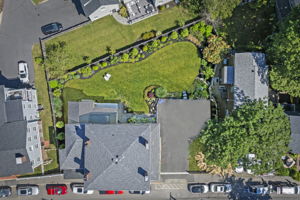 Aerial view of the home, driveway, and yard