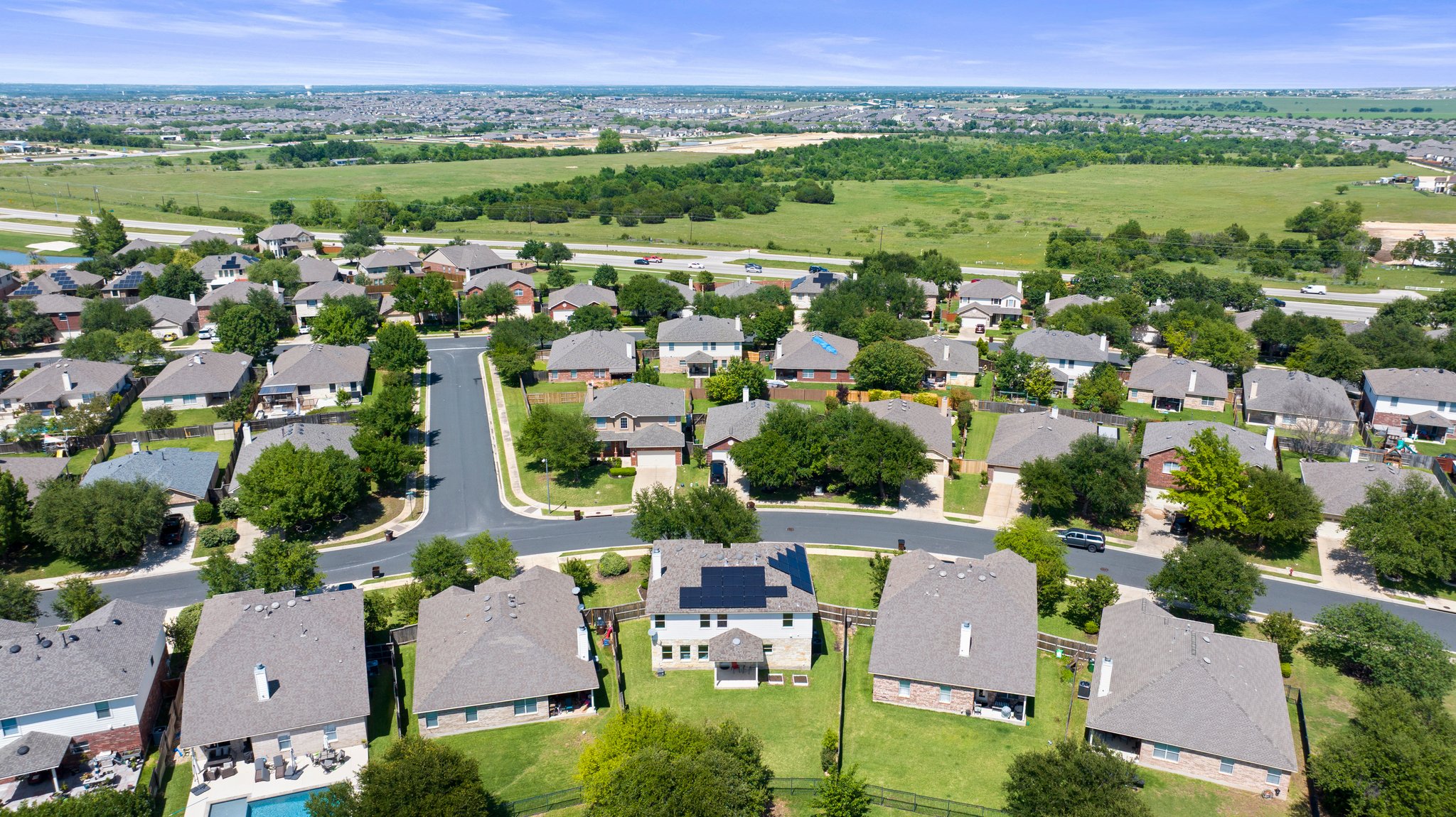 Large yard backing to a community pond.