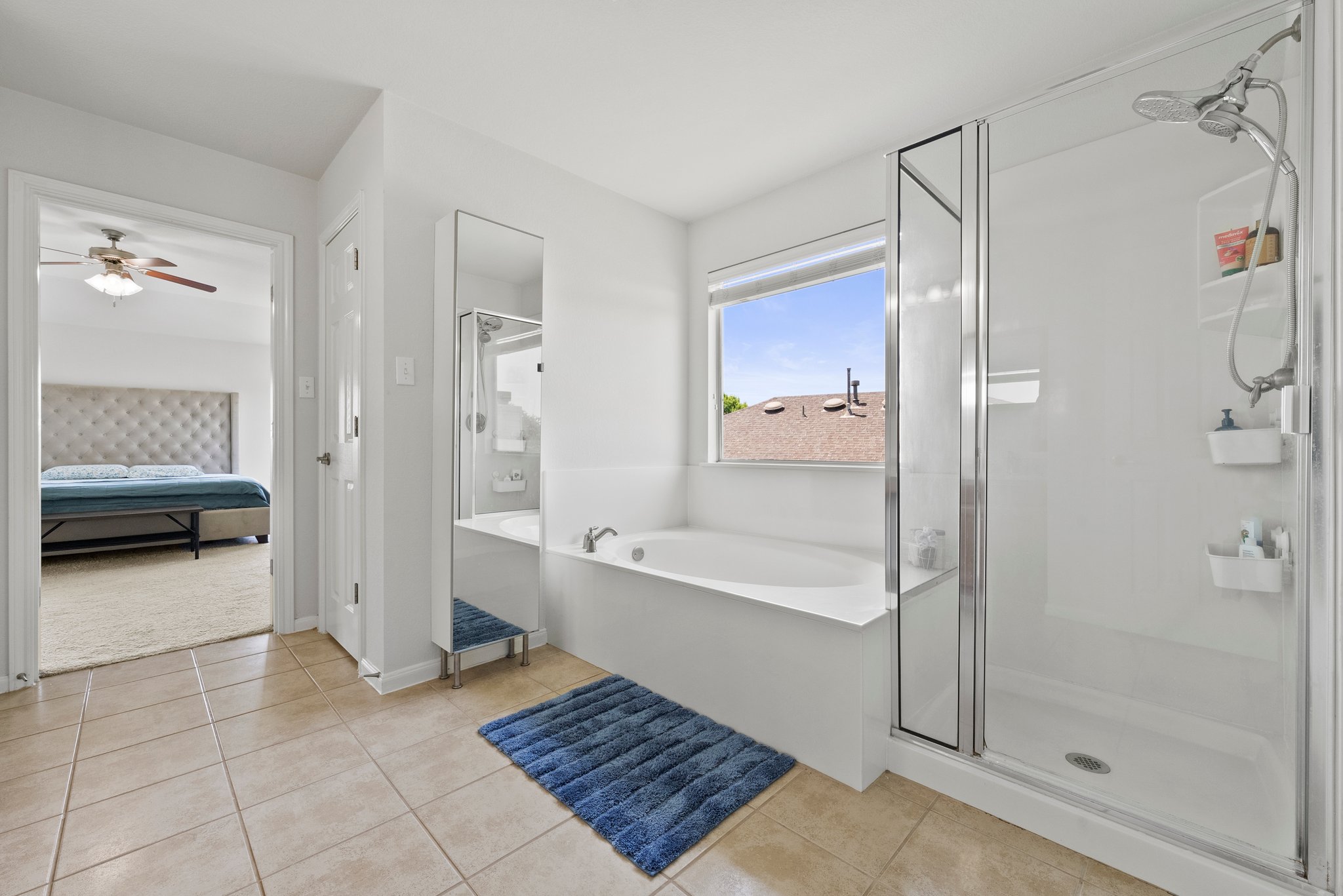Primary bedroom with double vanity, soaking tub and walk-in shower.