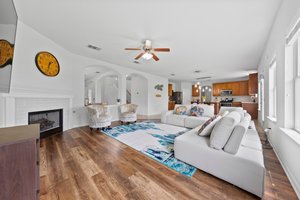 The main living area at the back of the house is open to the front living area, formal dining room, and kitchen.