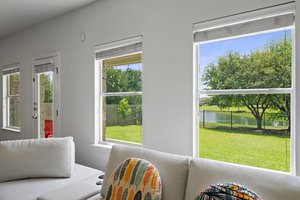 The main living area at the back of the house has a wall of windows looking out into the community pond. No back neighbors!