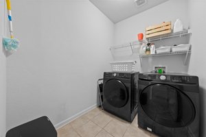 Laundry room on lower level next to the kitchen.