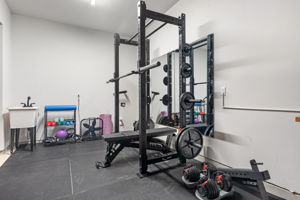 The 3rd car garage bay is currently used for the at-home gym. The space has a utility sink and is plumbed for a water softener.