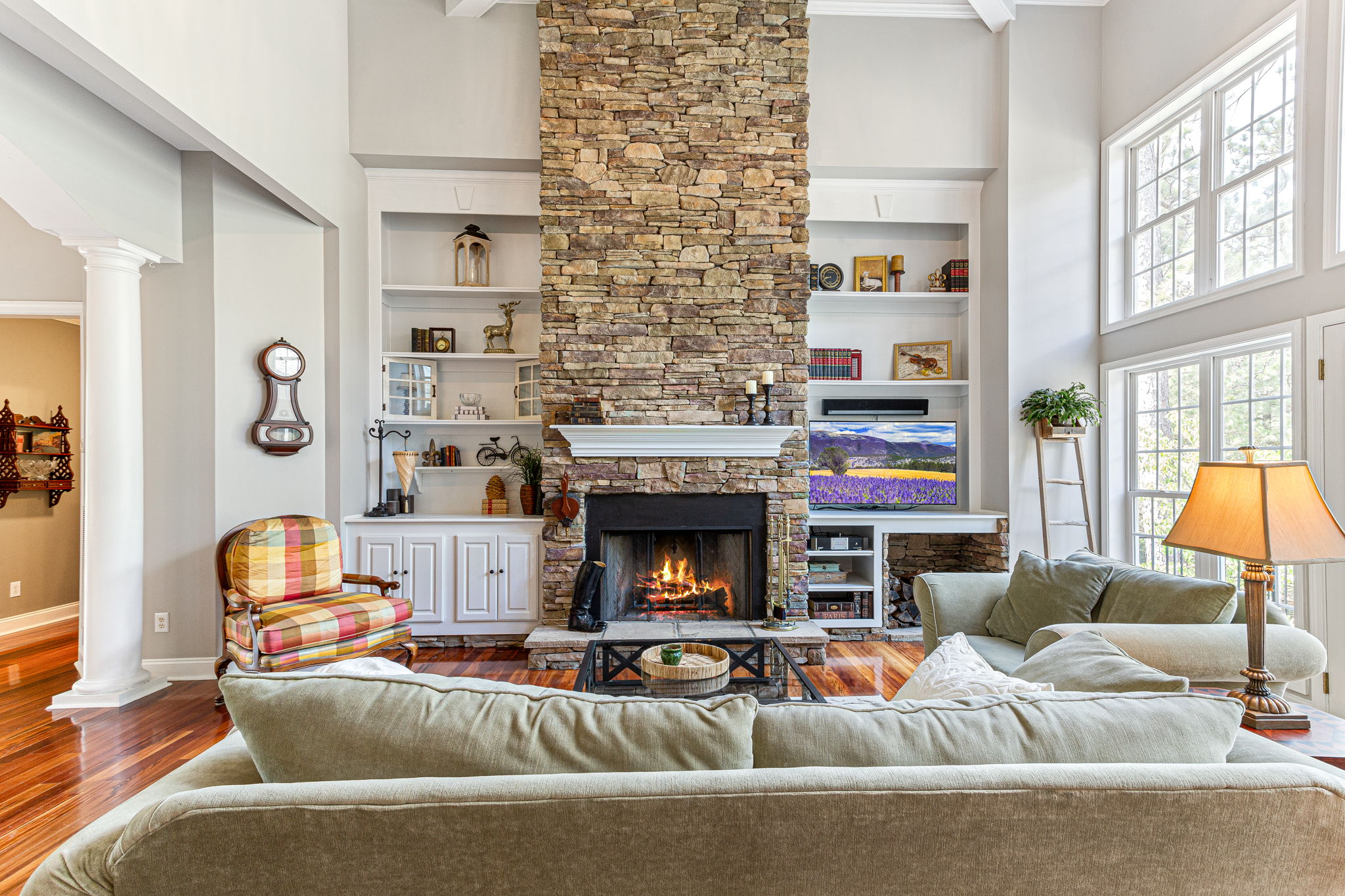 Dry stack stone wood burning fireplace with 12’ custom-built bookshelves.
