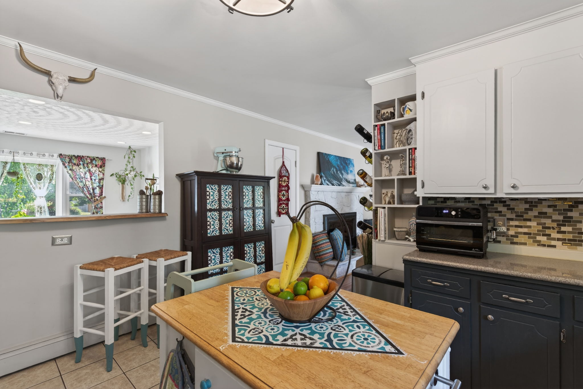 Kitchen flows seamlessly into dining and living spaces.