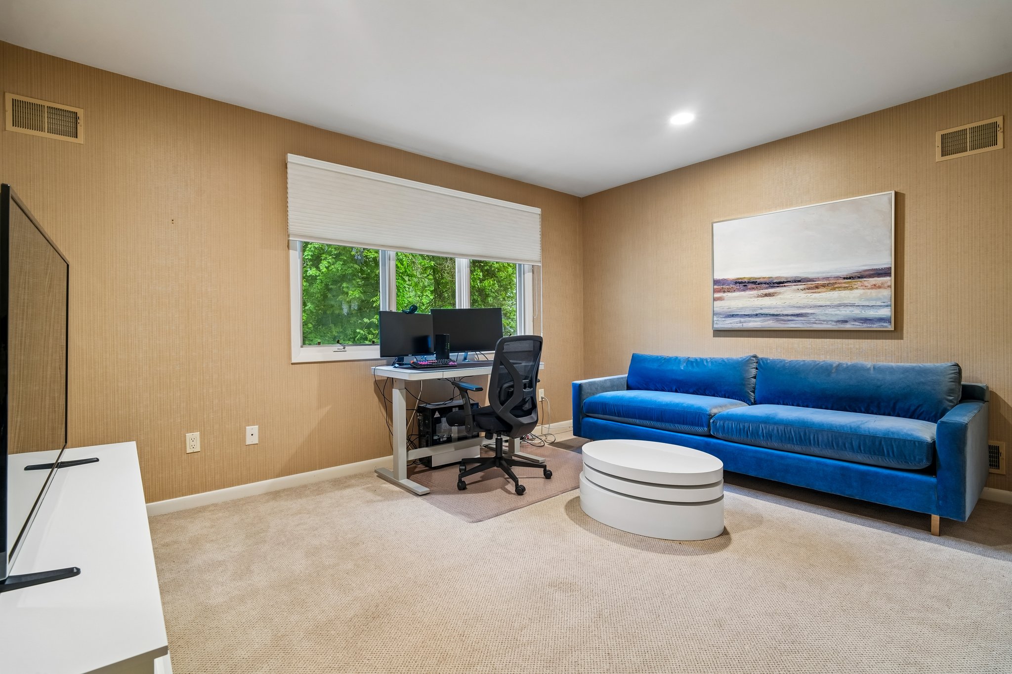 The third bedroom on the second floor is currently used as a home office, although it easily serves as a spacious fourth bedroom. With its signature wall of windows and generous double-door closet, this bright and versatile space adapts perfectly to your specific lifestyle needs.