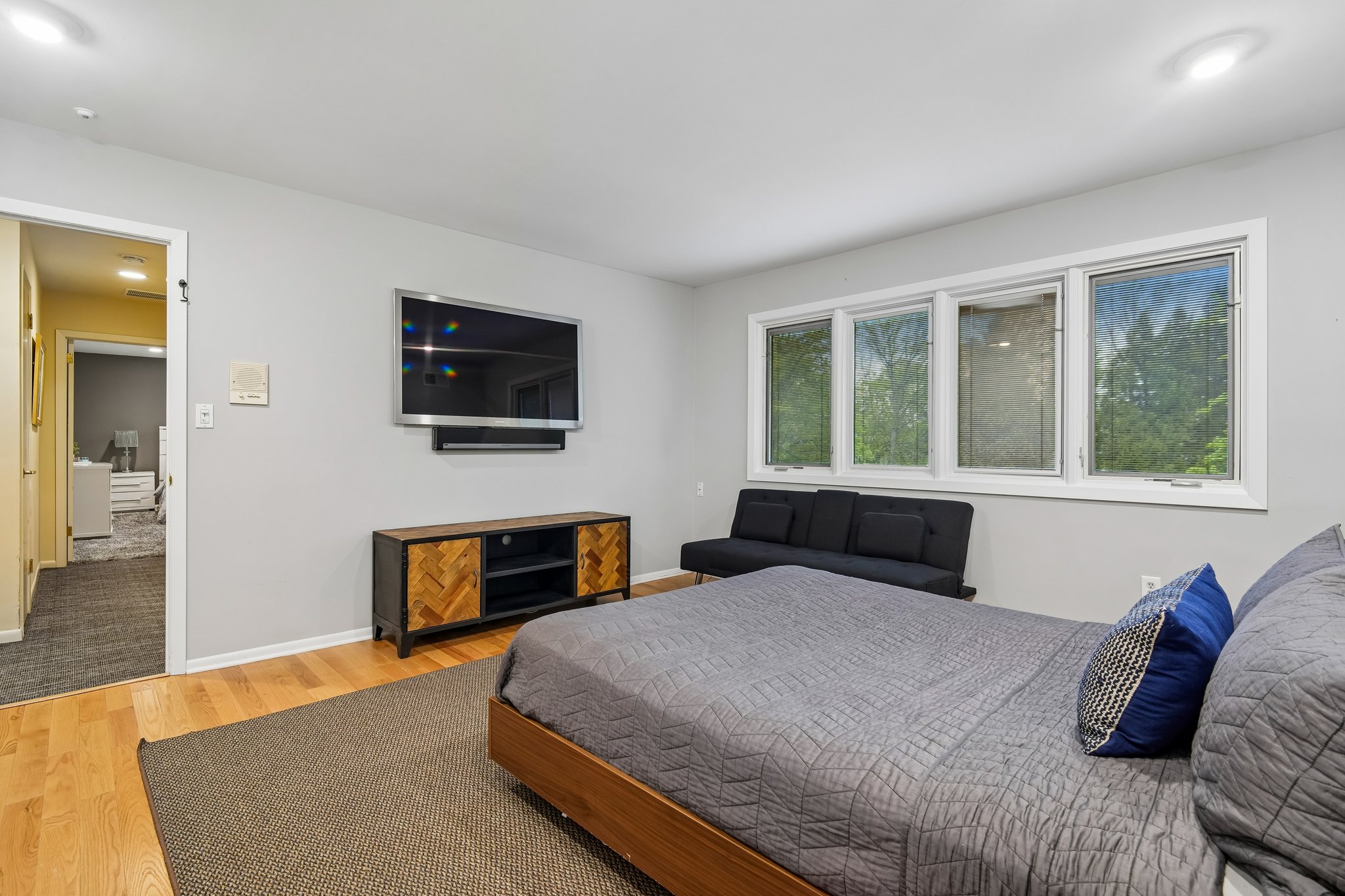 First of three generous second floor bedrooms, this sun-drenched bedroom is defined by a wall of windows that flood the space with natural light. Exceptional storage is provided by two double-door closets, making this spacious room both beautiful and highly functional.