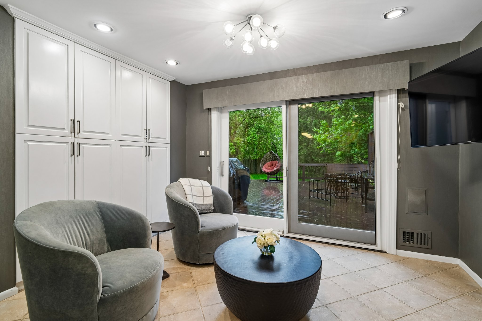 Access the outdoors with ease. A large sliding door connects the gourmet kitchen to a sprawling deck, offering a tranquil escape and beautiful views of the home's flat backyard.