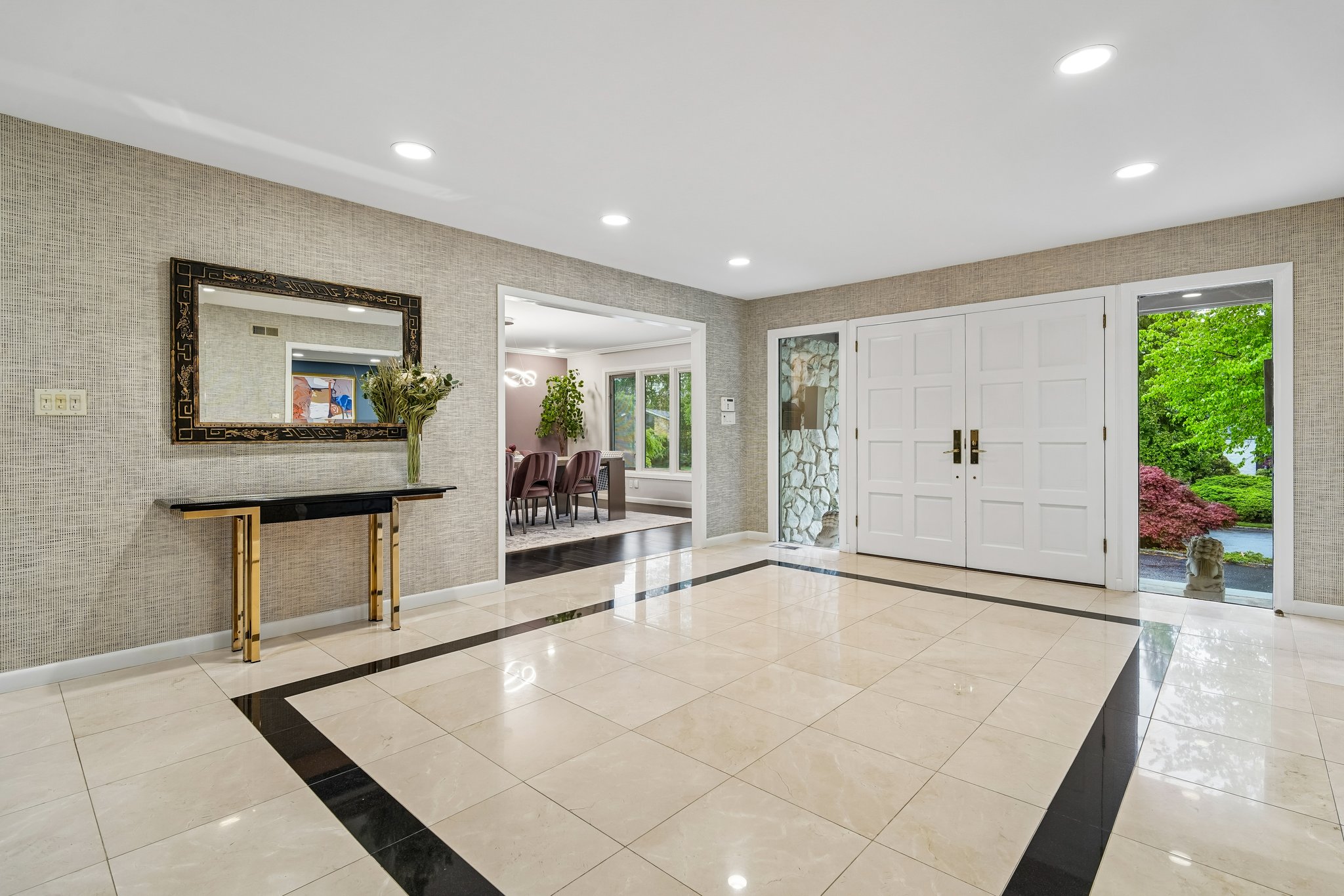 Featuring an airy, open flow with five bedrooms and 4.1 baths, this homes serves the perfect sanctuary for both grand entertaining and comfortable living. The elegant front double-doors lead to a sprawling foyer.