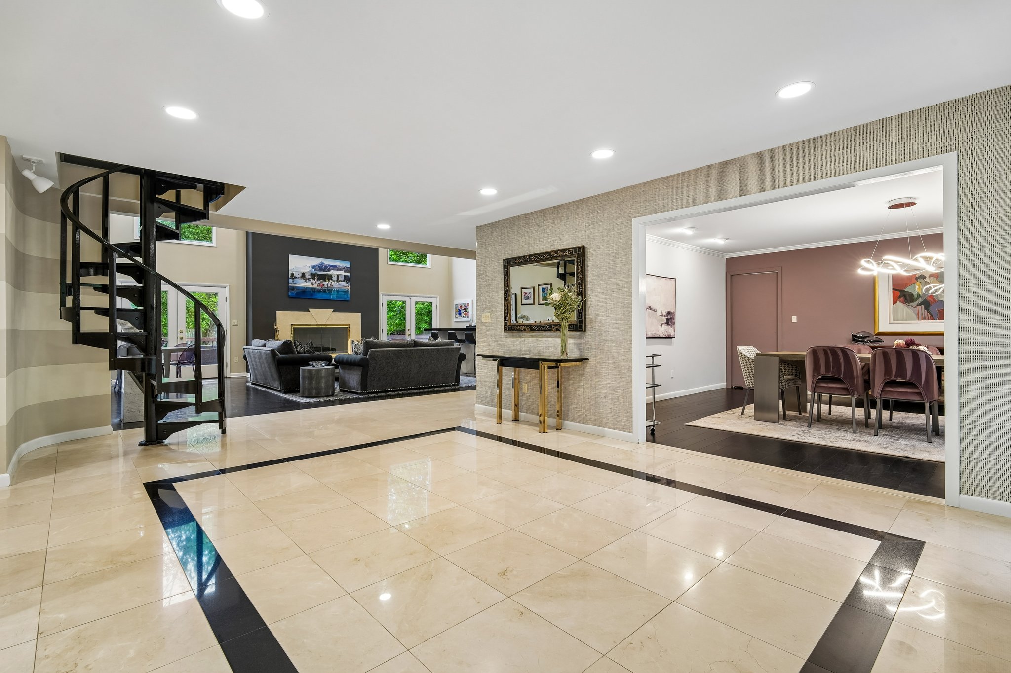 Another view of foyer looking intp formal dining room and second staircase leading to second floor.