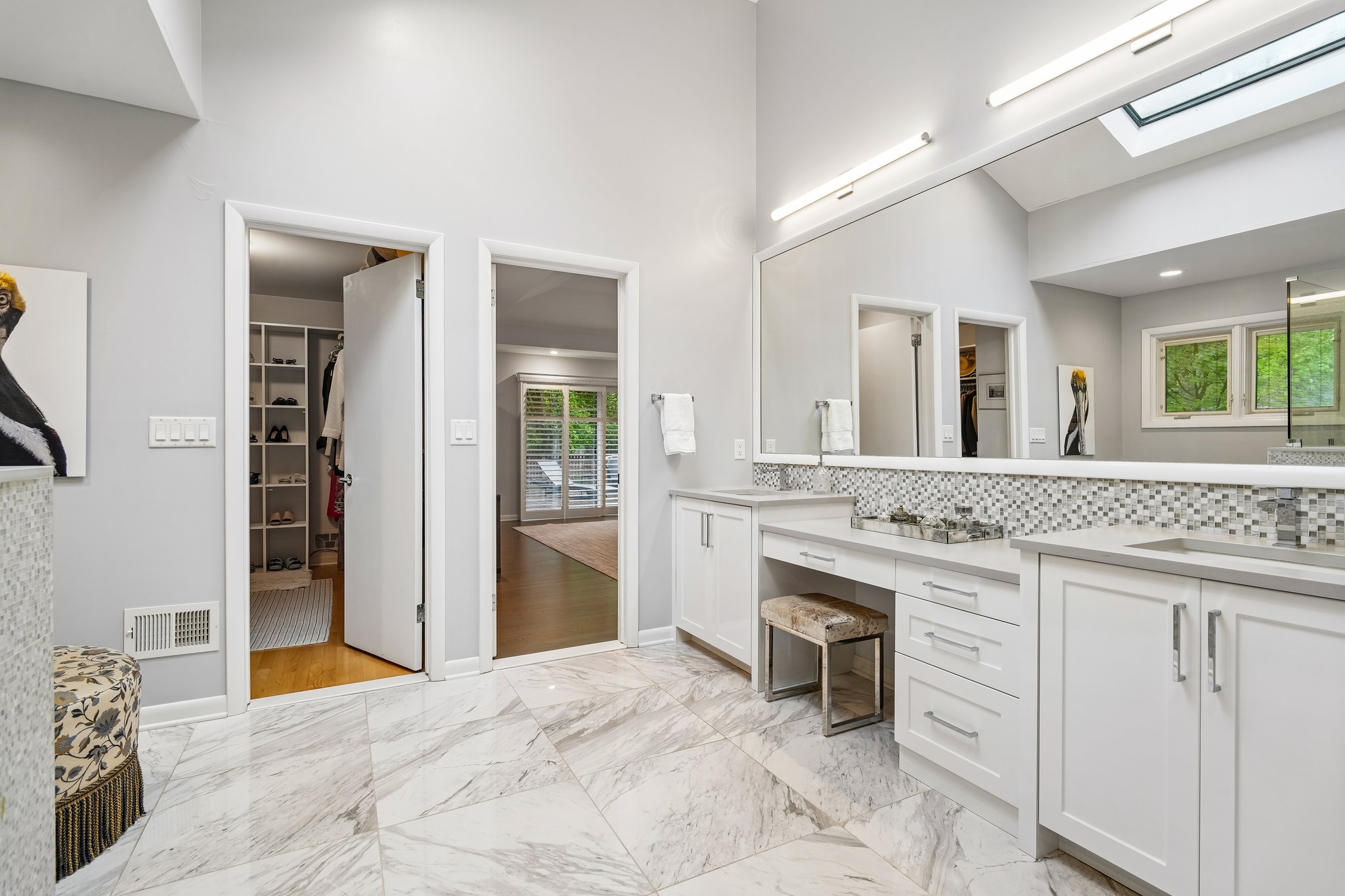 View from primary bathroom into one of two spacious walk-in closets.