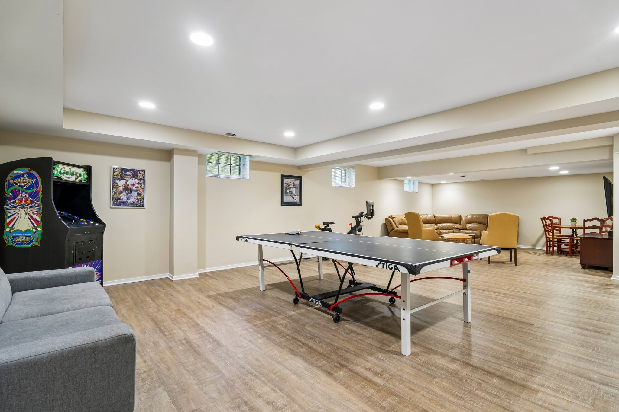 Spacious lower lower-level recreation room featuring dedicated areas for gaming, lounging, and entertaining. This bright, open-concept space offers limitless possibilities for oversized furniture, game tables and family gatherings.