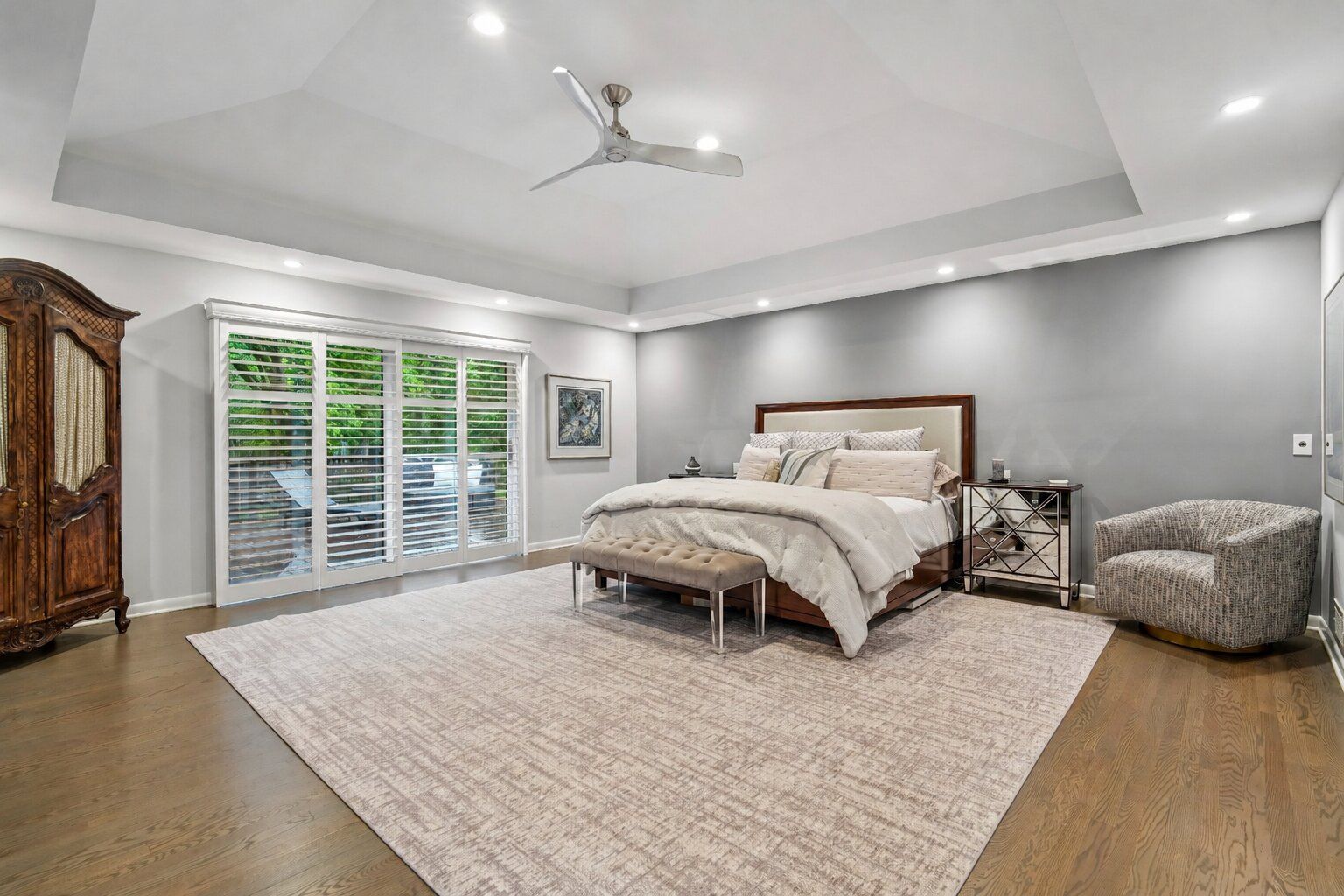 A stunning primary bedroom sanctuary with high ceilings and seamless access to the outdoors. The beautiful ensuite bathroom rivals any designer spa, complete with a dedicated make-up vanity, custom cabinetry with double sinks and a spectacular oversized shower, and two huge walk-in closets - perfect for a peaceful start to your day.