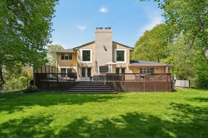 This sprawling deck spans the width of the house with outdoor TV and multiple entertainment zones overlooking a beautifully flat backyard. Seamlessly blending indoor comfort with outdoor recreation, this is the ultimate setting for hosting and playing.