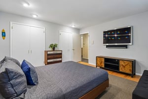 Another view of the first bedroom with two double-door closets.