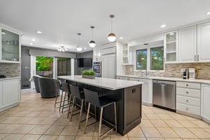 Another view of the kitchen with windows above the sink and a sliding glass door that lets in plenty of sunshine.