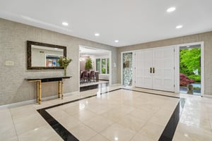 Featuring an airy, open flow with five bedrooms and 4.1 baths, this homes serves the perfect sanctuary for both grand entertaining and comfortable living. The elegant front double-doors lead to a sprawling foyer.