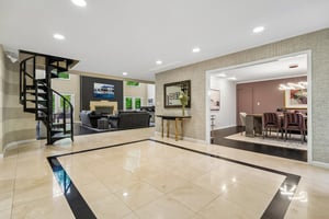 Another view of foyer looking intp formal dining room and second staircase leading to second floor.