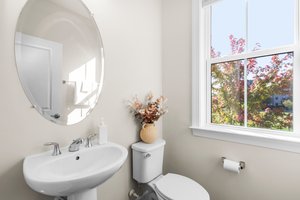 Convenient half bath w/pedestal sink on main level