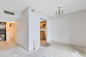 Living Room/Dining Room Combo with View to Kitchen and Hallway/Laundry Closet