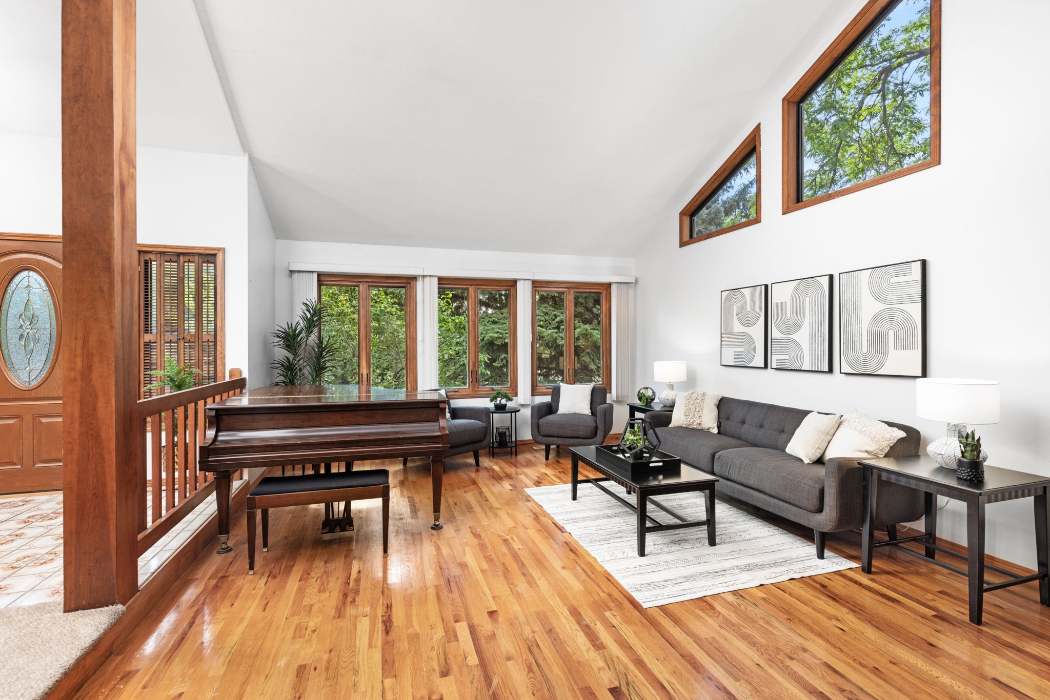 The Living Room With Soaring Ceilings and Hardwood Floors is a Great Place to Gather