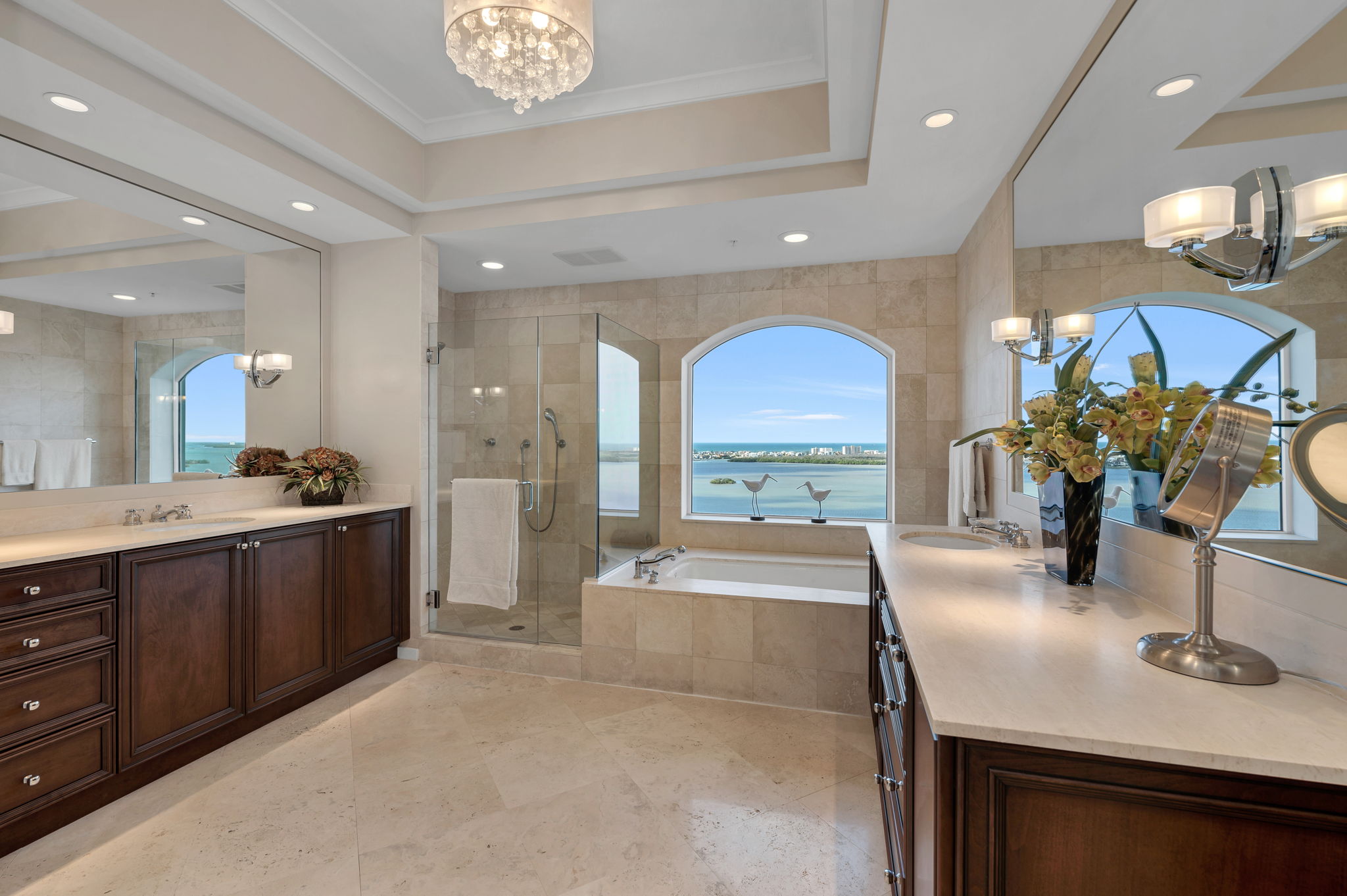 Primary en-suite with large picturesque window framing the blue sky and water.