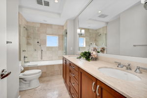 Guest Suite bathroom with dual sinks, marble and seamless shower glass