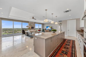 Kitchen has been re-imagined with new cabinetry, countertops, lighting, and open to Family Room and easy access to outdoor balcony