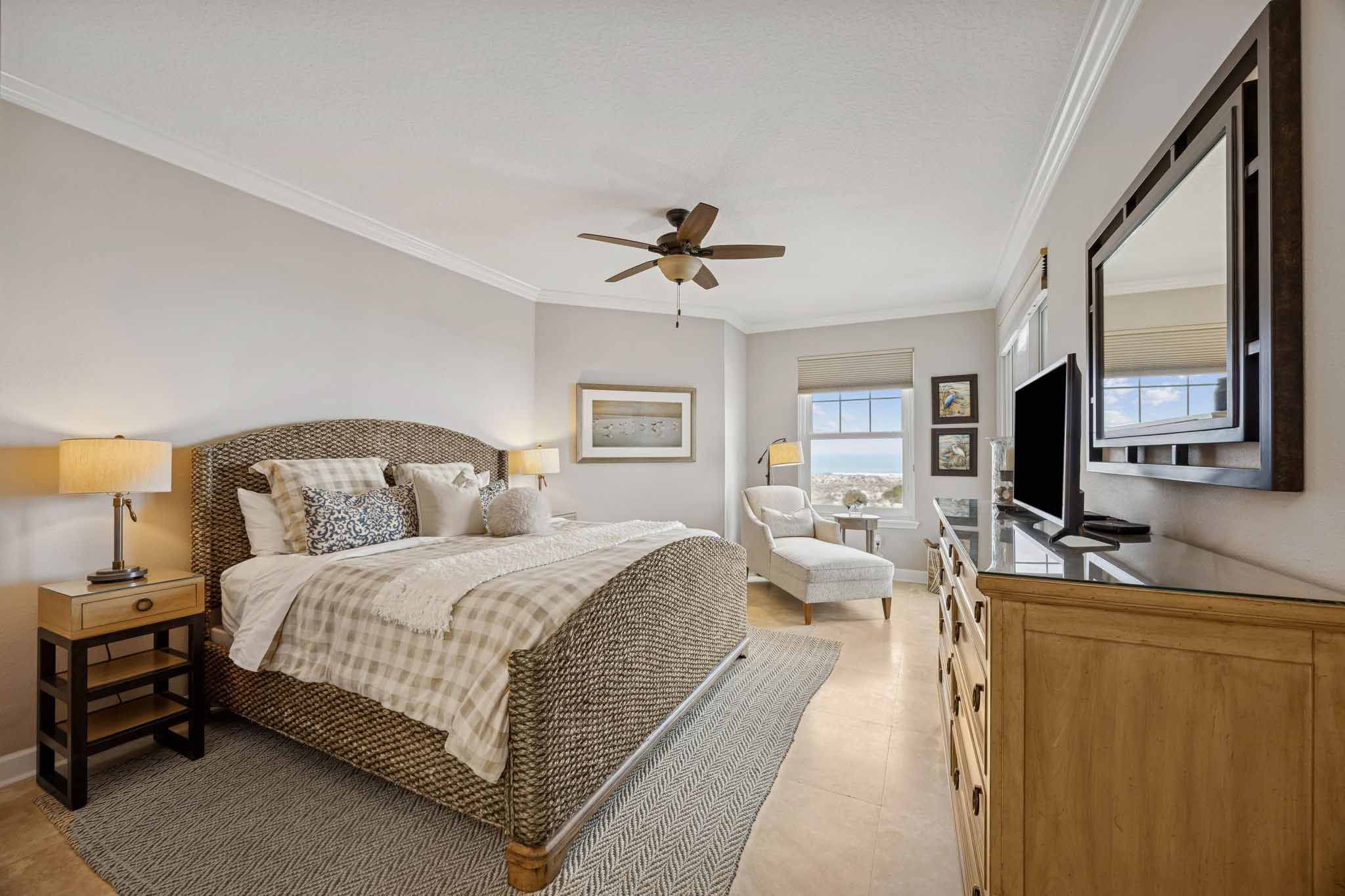 The primary suite offers a generous footprint and a seamless connection to the balcony beyond ...