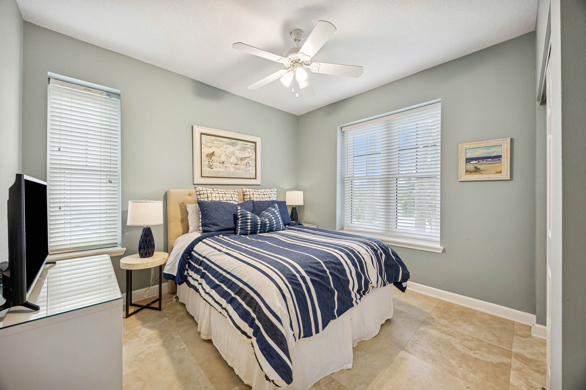 One guest bedroom offers a queen bed, quality furnishings, and a soothing coastal palette ...