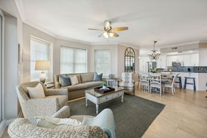 The open living areas are bright, spacious, and designed to flow seamlessly from gathering spaces to the remodeled kitchen beyond.