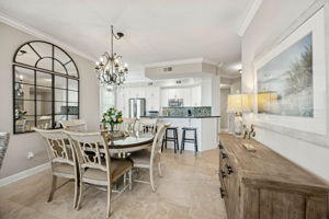 Crown molding, 9-foot ceilings, and a soft coastal palette keep the main living spaces feeling bright and refined with an easy flow.