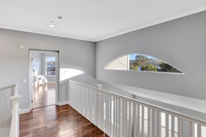 THE BRIDGE WITH VIEWS LEADING TO THE PRIMARY BEDROOM