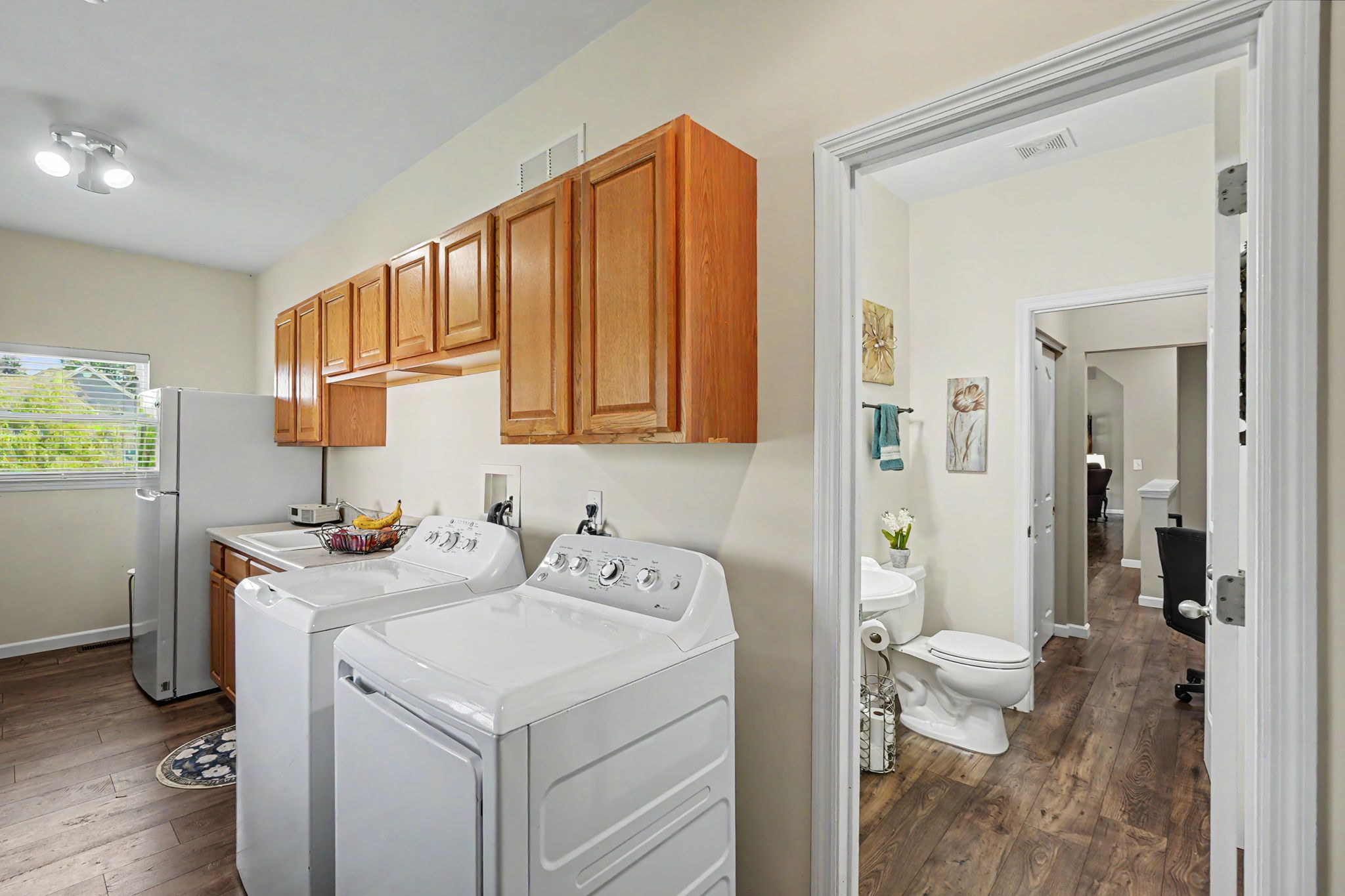 Spacious main floor laundry with cabinets.