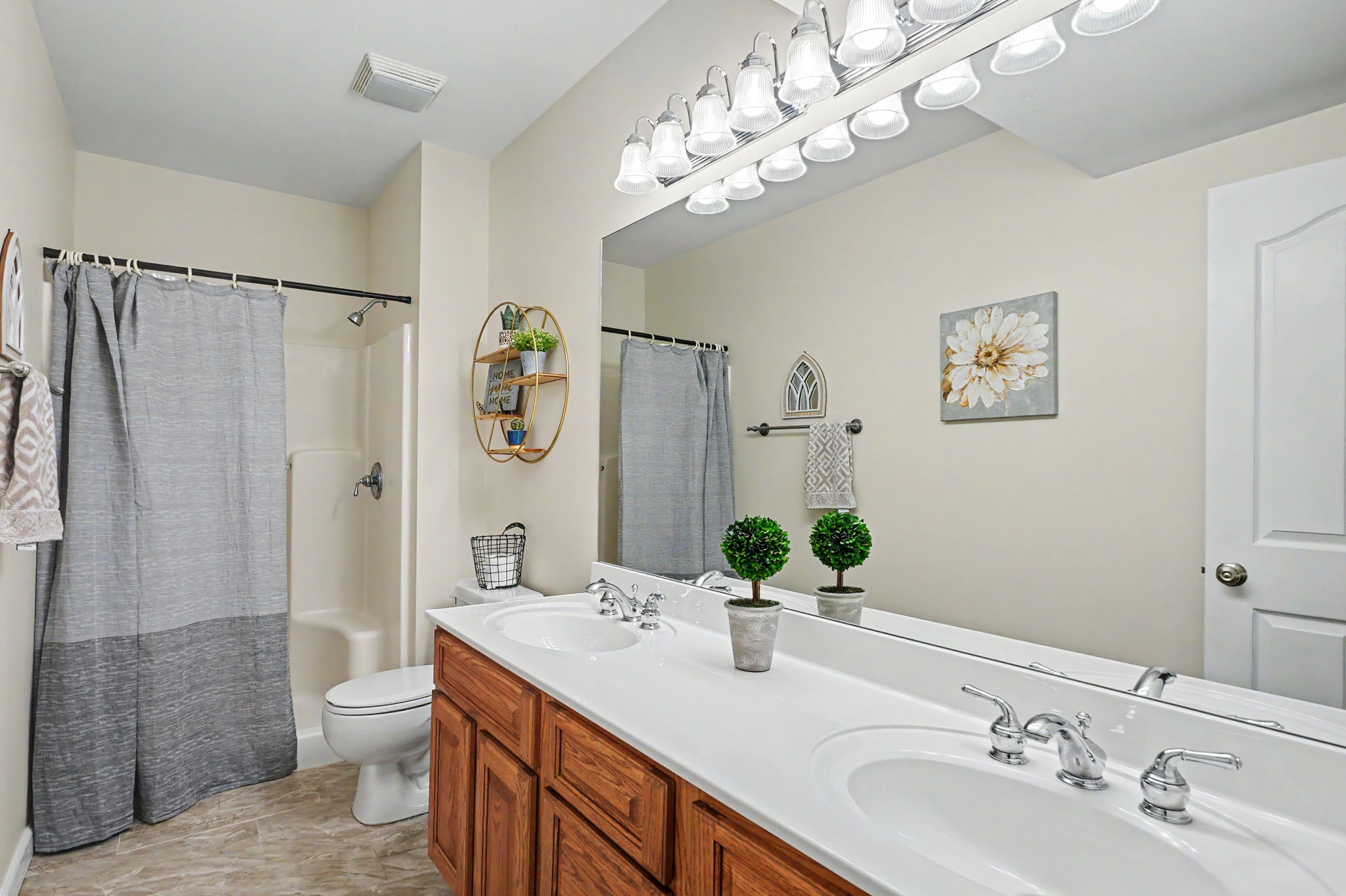 Full bathroom in the lower level with double vanity and walk-in shower.