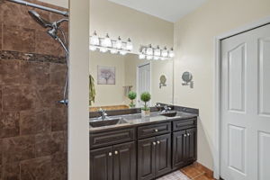 Private Primary Bath with double bowl vanity and ceramic tiled shower.