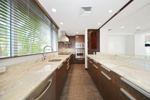 Gourmet chef kitchen with enclosed shutters to block off work station from entertainment area