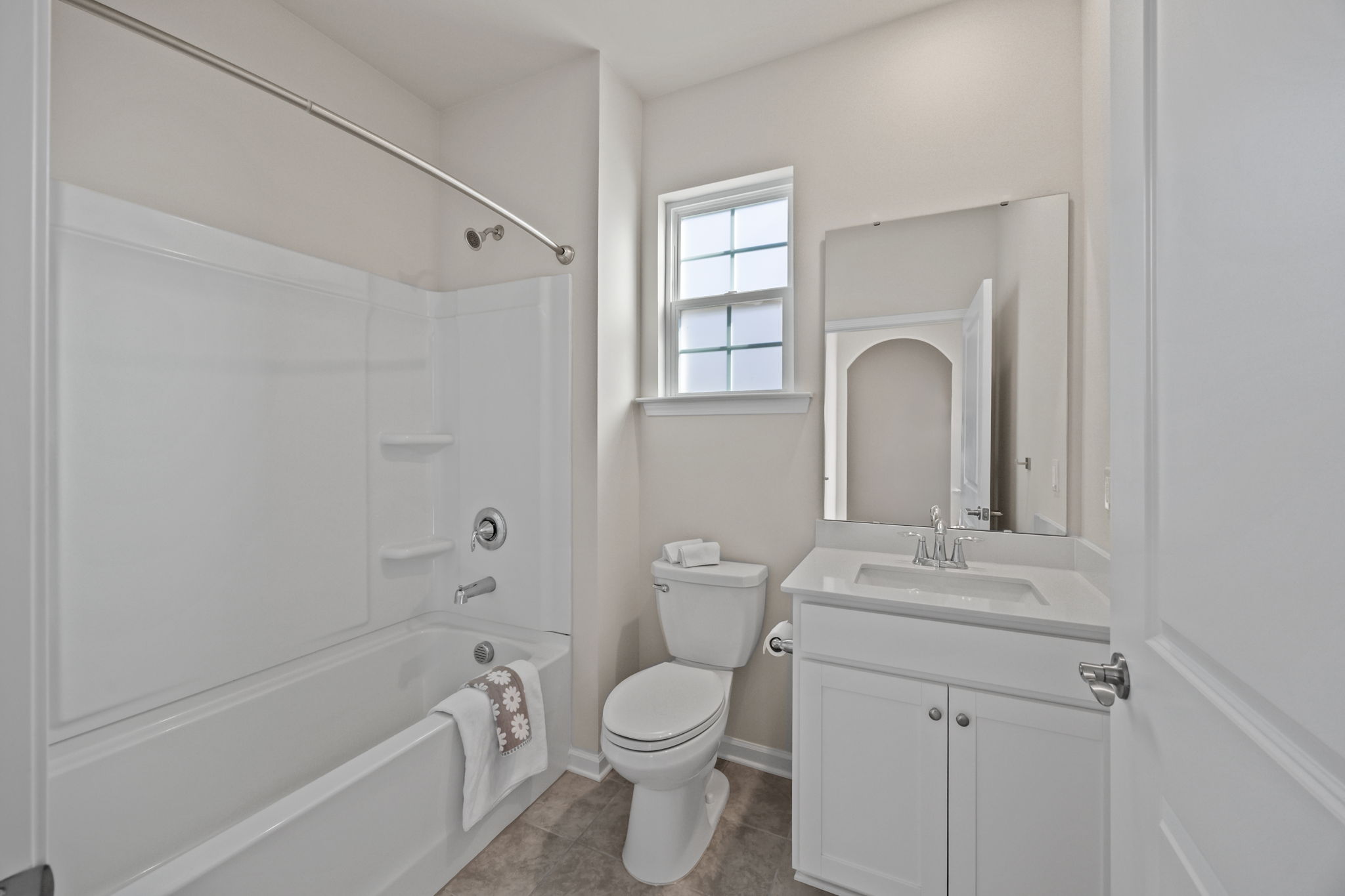 Light-filled Full Bath has arched doorway offset entry for privacy and is located next of Office/Bedroom #1.